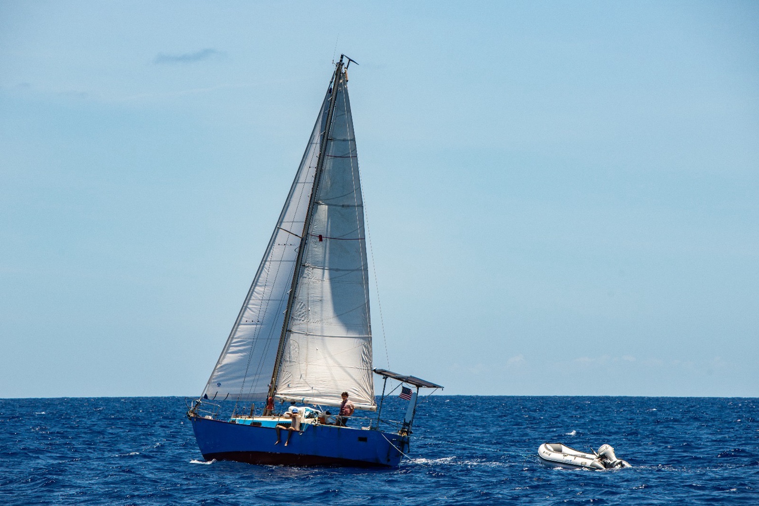 Boat sailing with dinghy