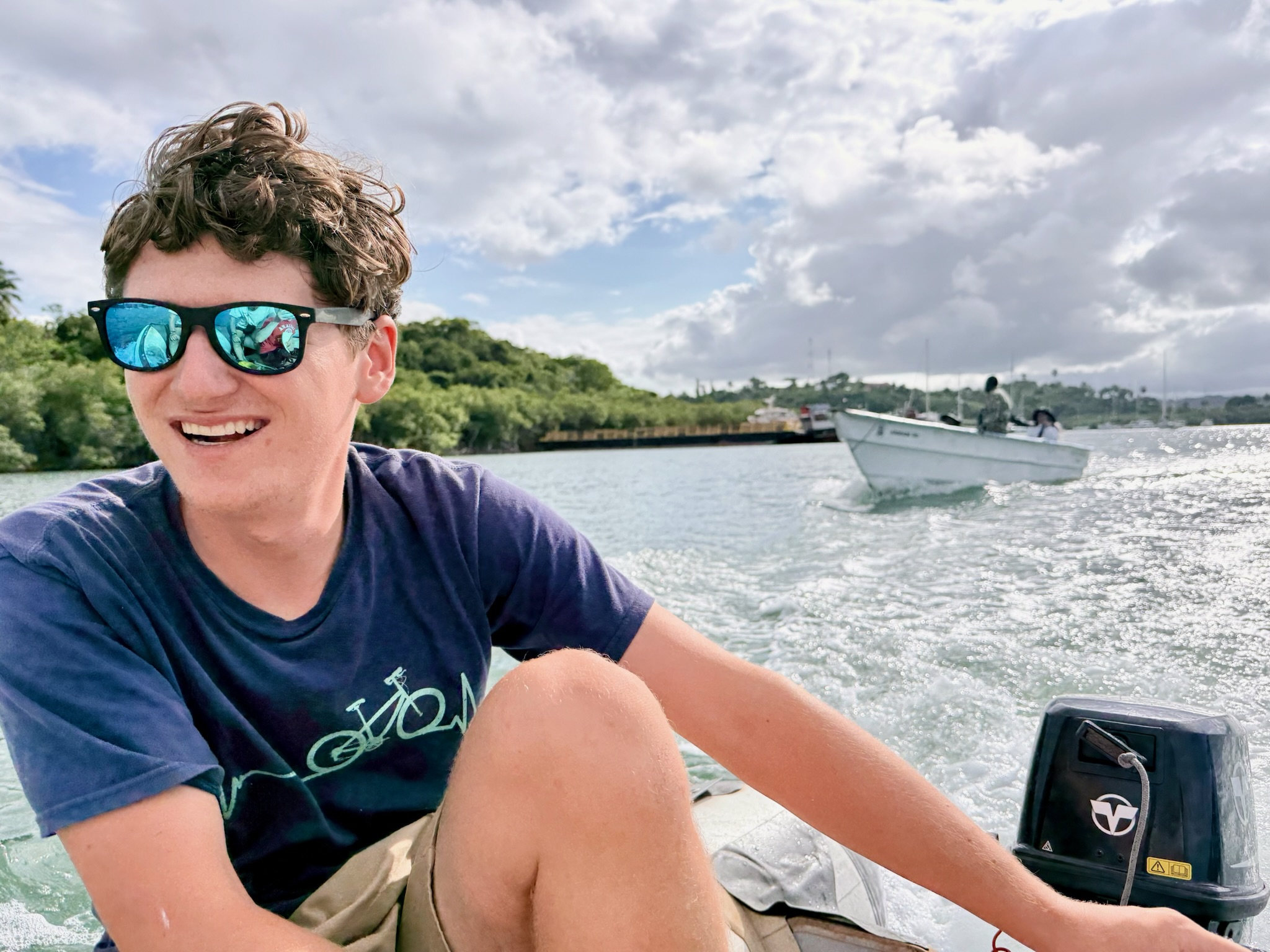 Captain Damian steering a dinghy on the water