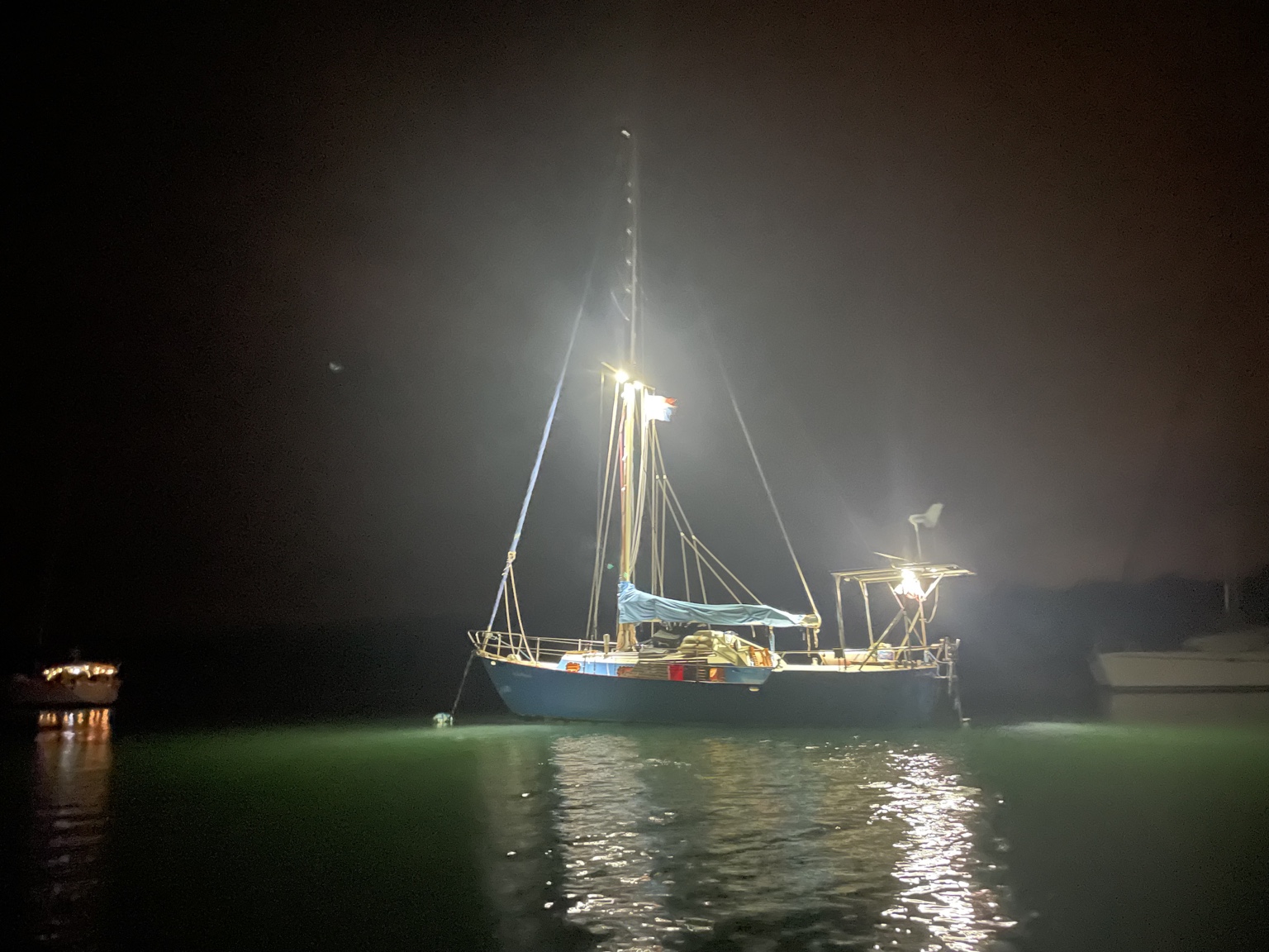 Boat lit at anchor at night